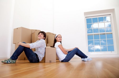 Removal team planning a move with boxes and protective wrapping