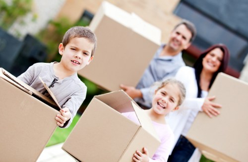Professional movers unloading boxes and furniture at a new home